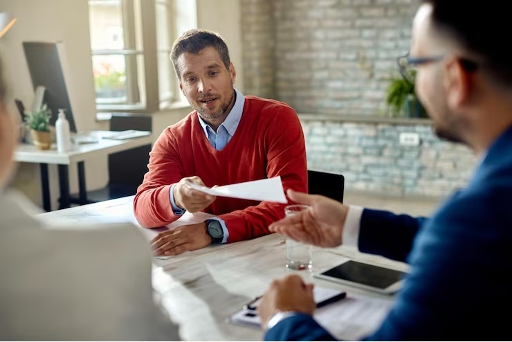 a person handing over loan approval document