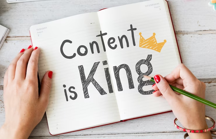 an open note book with 'content is the king written'
