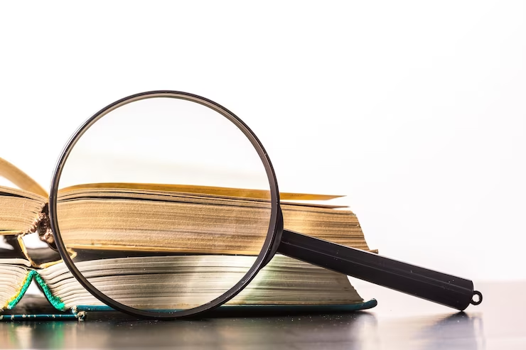 a magnifying glass magnifying book piles