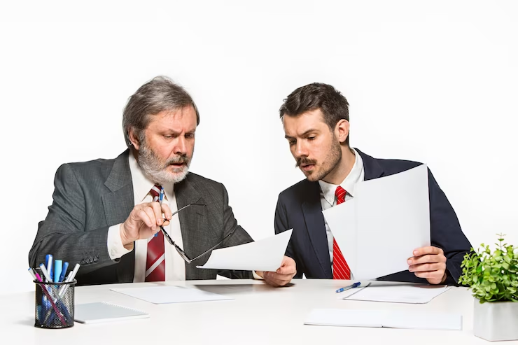 two men watching on a paper with due diligence